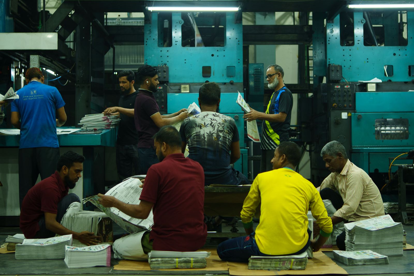 Press operators at work in the printing facility