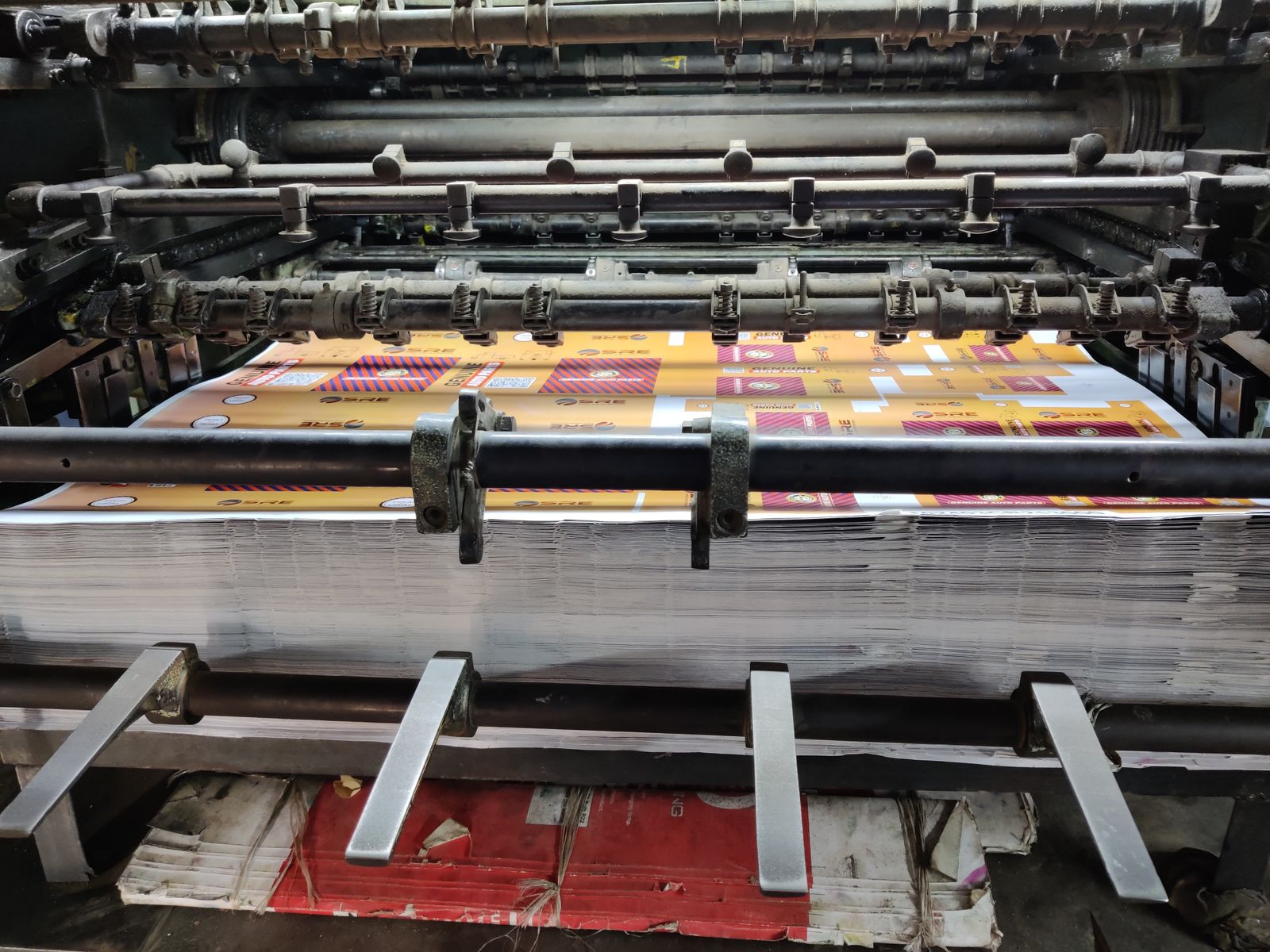 An offset press running a full-colour print job